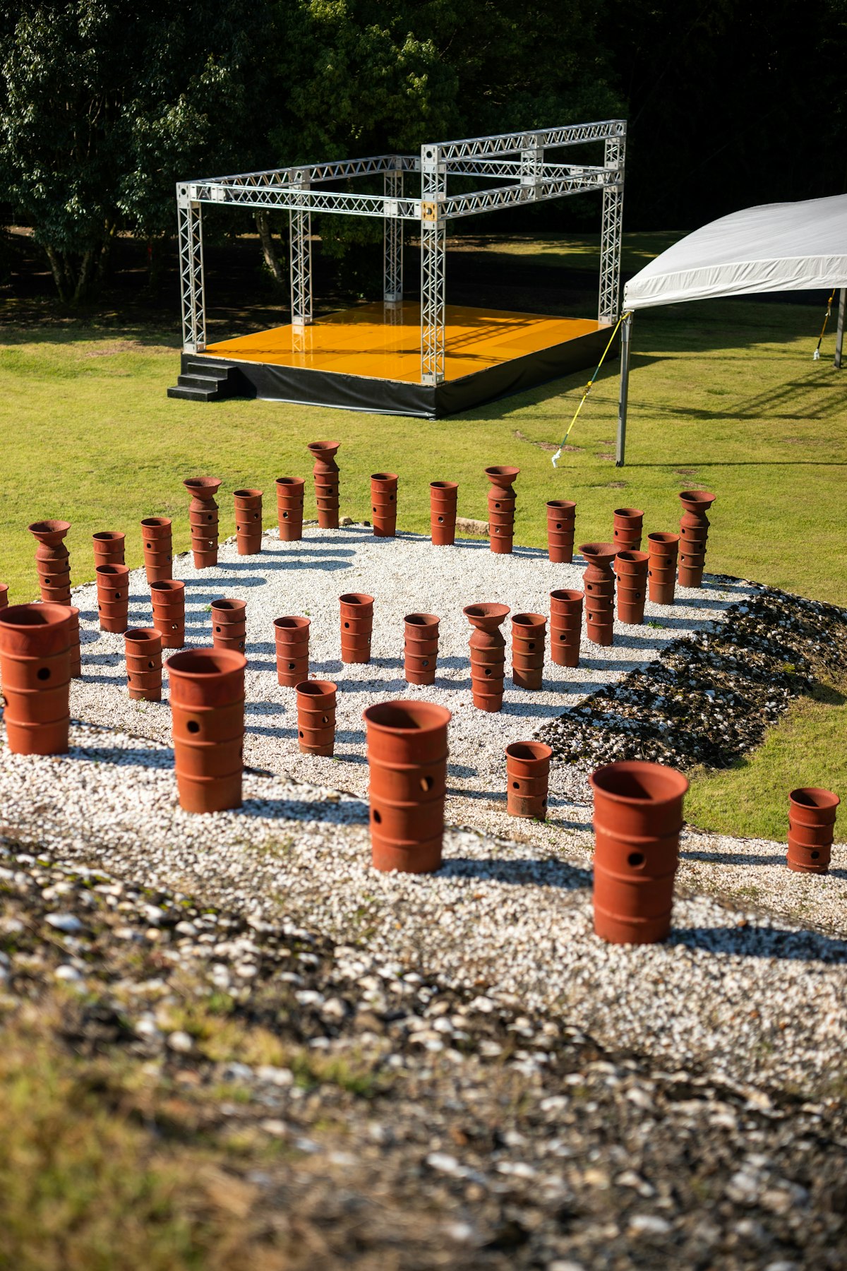 Raised outdoor stage with a metal truss frame and temporary seating
